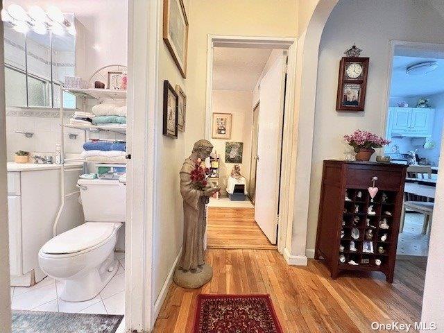 219-36 74th Ave Unit 323A1, Bayside, NY 11364 - hallway featuring light wood-type flooring and arched walkways