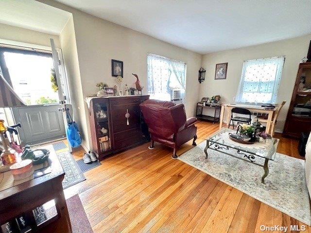 219-36 74th Ave Unit 323A1, Bayside, NY 11364 - living area featuring healthy amount of natural light and light wood finished floors