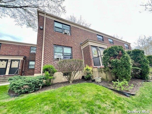 219-36 74th Ave Unit 323A1, Bayside, NY 11364 - colonial home featuring brick siding and a front lawn