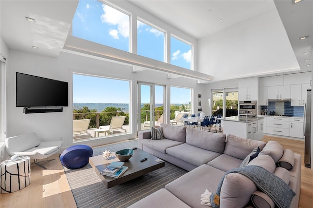 846 Dune Rd, Westhampton Dunes, NY 11978 - living area with light wood-style flooring, a high ceiling, and recessed lighting