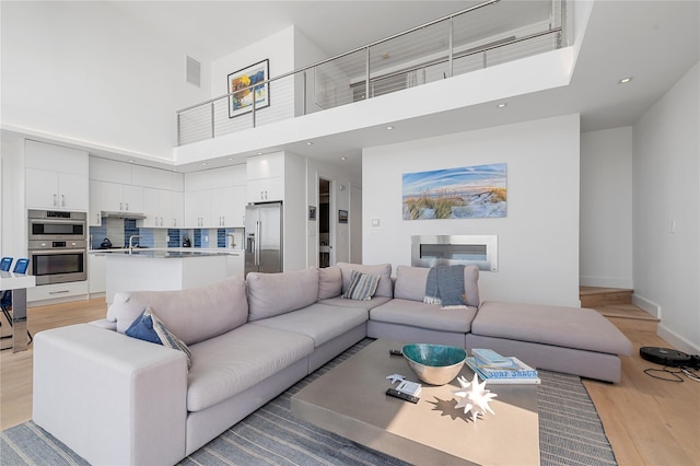 846 Dune Rd, Westhampton Dunes, NY 11978 - living area featuring a towering ceiling, light wood-style floors, and recessed lighting