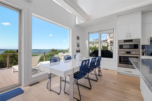 846 Dune Rd, Westhampton Dunes, NY 11978 - dining area with light wood-type flooring, a water view, and recessed lighting
