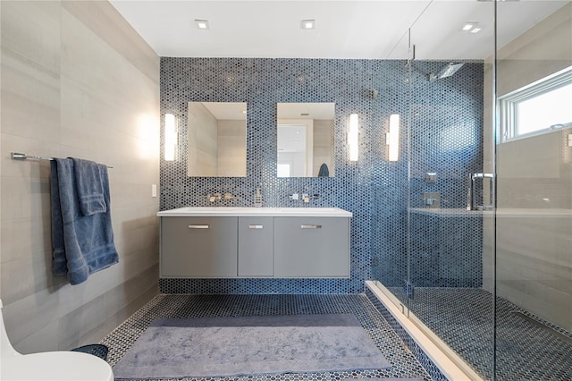 846 Dune Rd, Westhampton Dunes, NY 11978 - full bathroom with double vanity, a shower stall, and tile walls
