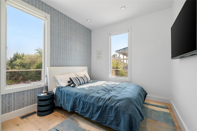 846 Dune Rd, Westhampton Dunes, NY 11978 - bedroom featuring wallpapered walls and wood finished floors