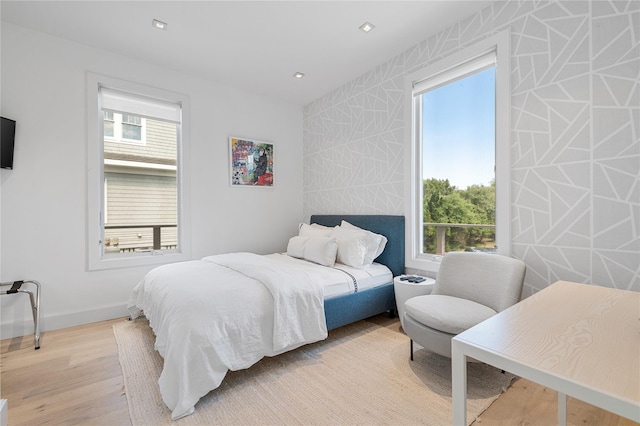 846 Dune Rd, Westhampton Dunes, NY 11978 - bedroom with light wood finished floors, an accent wall, and recessed lighting