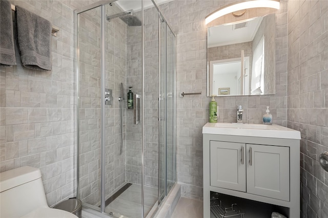 846 Dune Rd, Westhampton Dunes, NY 11978 - bathroom featuring tile walls, a stall shower, and vanity