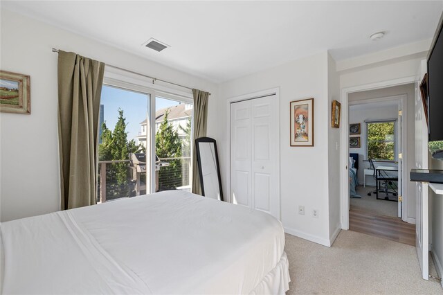 846 Dune Rd, Westhampton Dunes, NY 11978 - bedroom featuring light colored carpet, multiple windows, and a closet