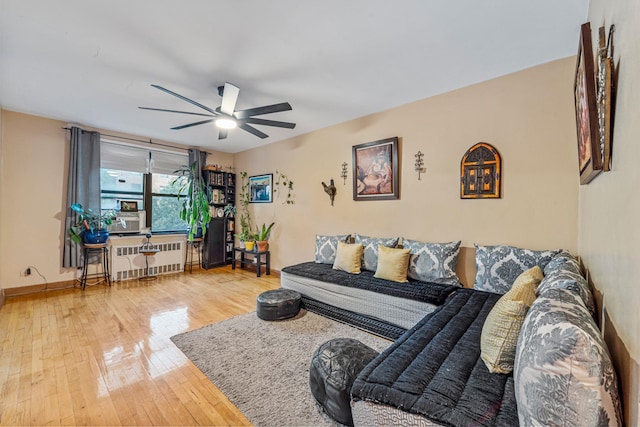 7910 34th Ave Unit 4J, Jackson Heights, NY 11372 - living room featuring radiator, wood-type flooring, and ceiling fan
