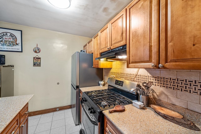 7910 34th Ave Unit 4J, Jackson Heights, NY 11372 - kitchen featuring gas range, under cabinet range hood, light tile patterned floors, light stone countertops, and backsplash