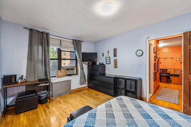 7910 34th Ave Unit 4J, Jackson Heights, NY 11372 - bedroom featuring wood-type flooring and an office area
