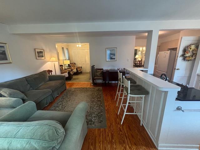 89 Hampton Ave, Albertson, NY 11507 - living room featuring dark wood-type flooring, a chandelier, and beam ceiling