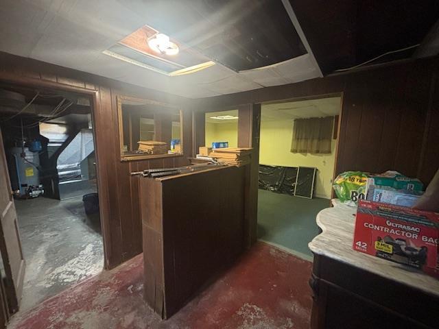 89 Hampton Ave, Albertson, NY 11507 - finished below grade area featuring water heater and wood walls