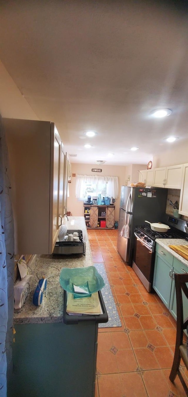 30 Chestnut Cir, Staten Island, NY 10312 - kitchen featuring gas range, light tile patterned flooring, white cabinets, and recessed lighting