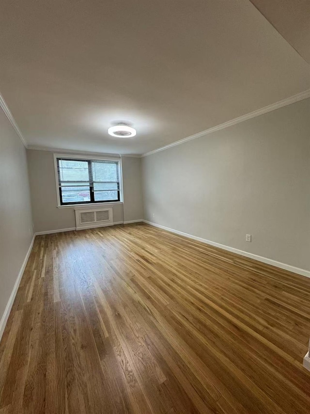 138-18 28th Rd Unit 1F, Flushing, NY 11354 - unfurnished room featuring ornamental molding and wood finished floors