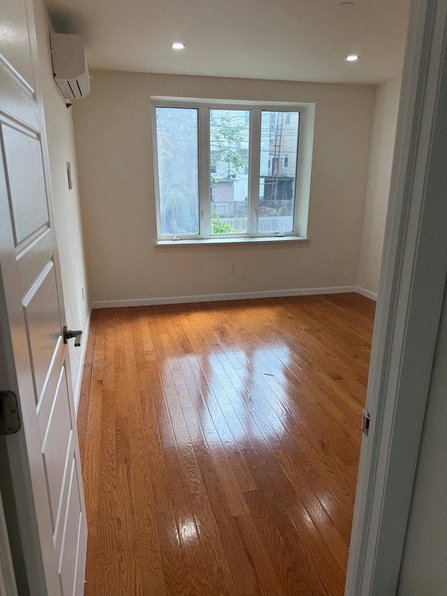 756 40th St Unit 2R, Brooklyn, NY 11232 - spare room with light wood-type flooring, a wall mounted AC, and recessed lighting
