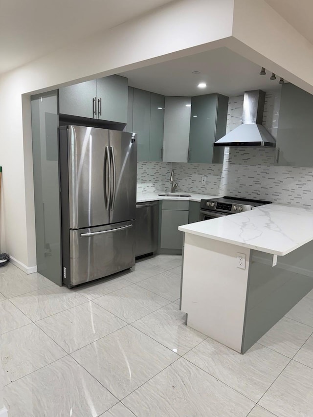 756 40th St Unit 2R, Brooklyn, NY 11232 - kitchen featuring appliances with stainless steel finishes, a peninsula, wall chimney range hood, gray cabinets, and tasteful backsplash