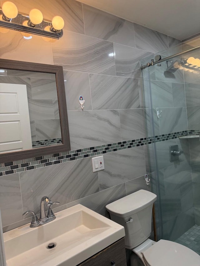 756 40th St Unit 2R, Brooklyn, NY 11232 - bathroom featuring a shower stall, vanity, decorative backsplash, and tile walls
