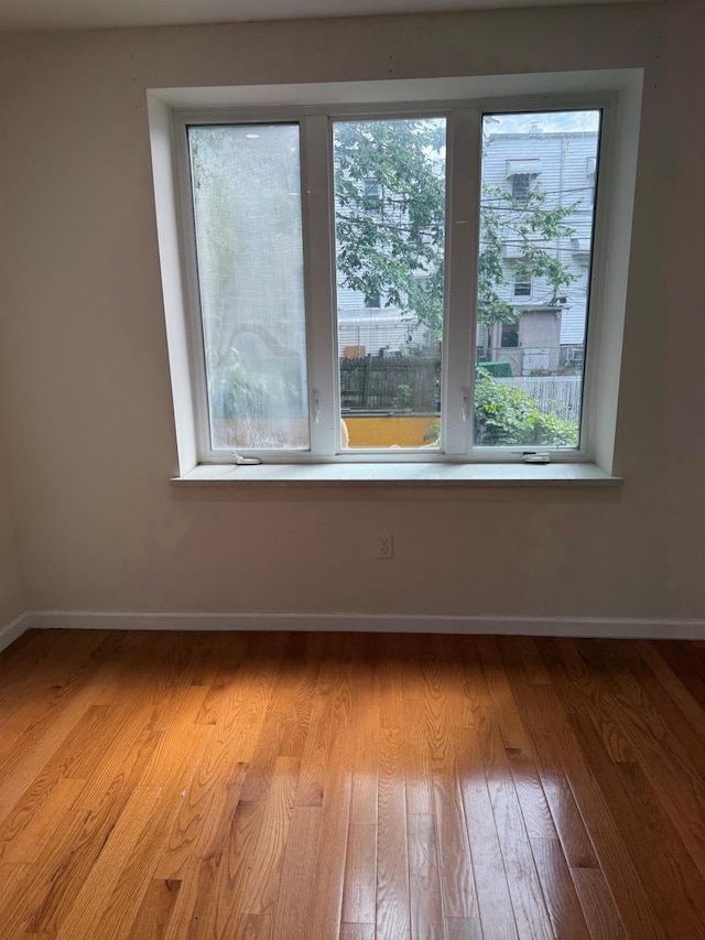 756 40th St Unit 2R, Brooklyn, NY 11232 - unfurnished room with baseboards and light wood-style flooring