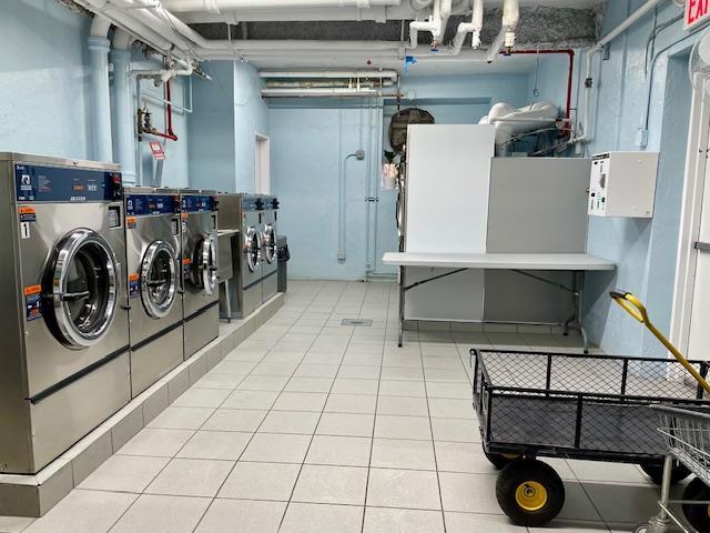 23-20 Bell Blvd Unit 2D, Bayside, NY 11360 - shared laundry featuring independent washer and dryer and tile patterned flooring