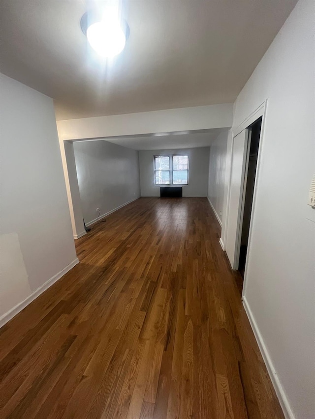 285 E 35th St Unit 2D, Brooklyn, NY 11203 - spare room featuring dark wood-style flooring and baseboards