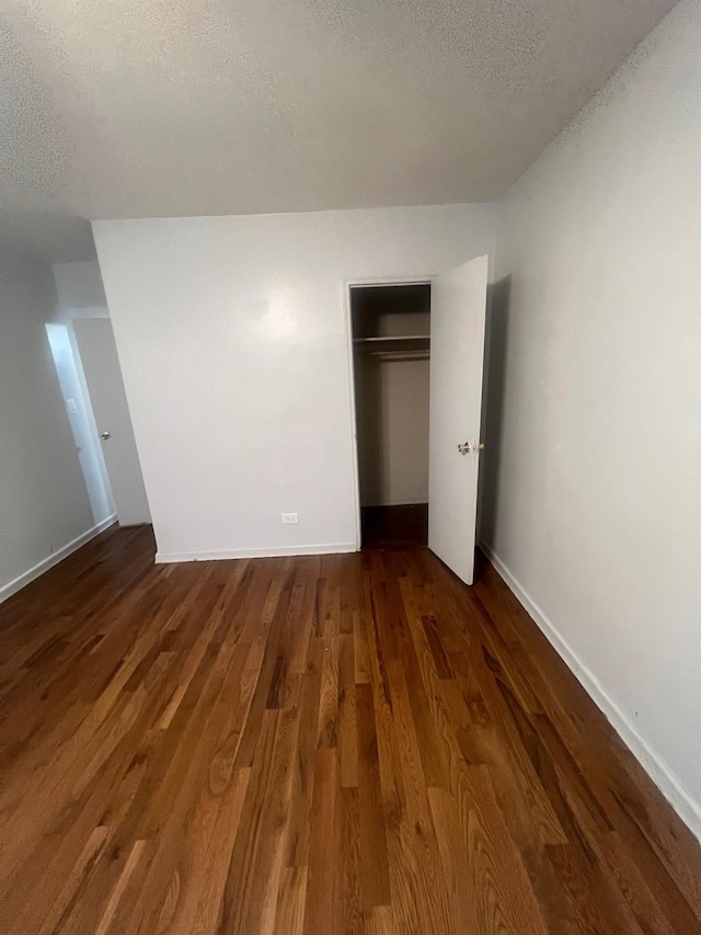 285 E 35th St Unit 2D, Brooklyn, NY 11203 - unfurnished bedroom featuring a textured ceiling, wood finished floors, and a closet