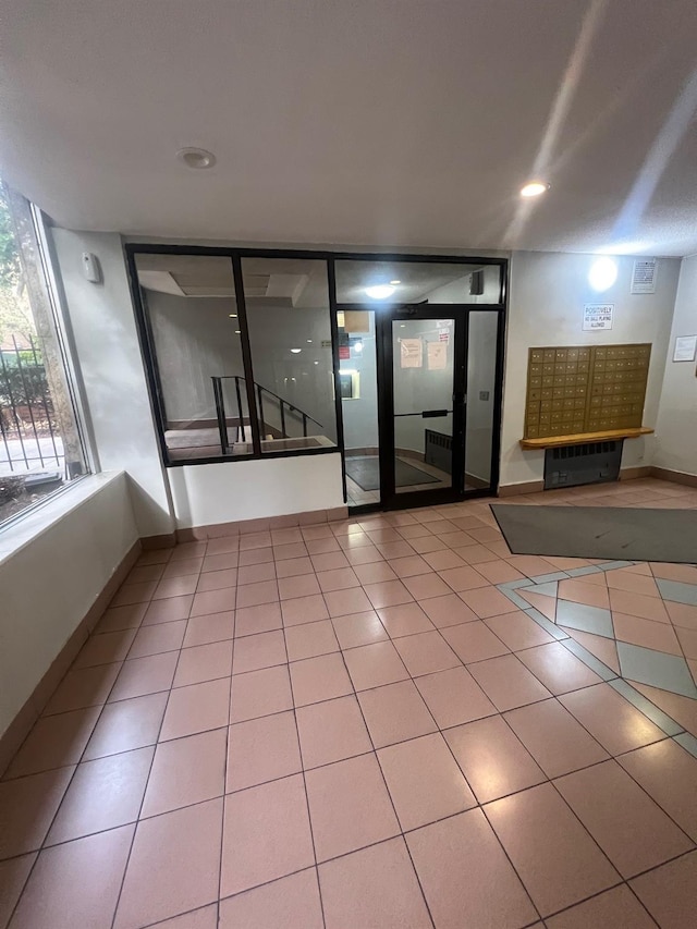 285 E 35th St Unit 2D, Brooklyn, NY 11203 - spare room featuring tile patterned flooring and mail area