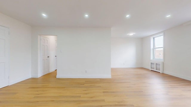 66-15 Thornton Pl Unit 6S, Rego Park, NY 11374 - spare room featuring light wood finished floors, radiator heating unit, and recessed lighting