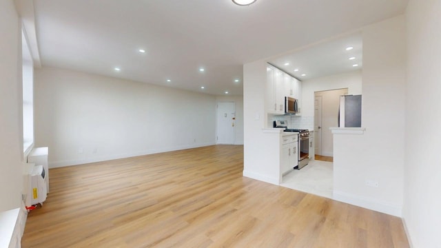 66-15 Thornton Pl Unit 6S, Rego Park, NY 11374 - unfurnished living room with recessed lighting and light wood-style flooring