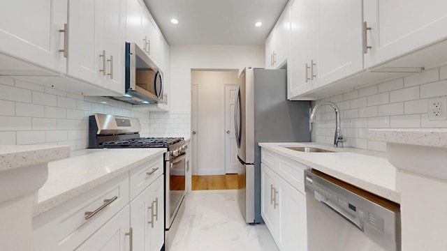 66-15 Thornton Pl Unit 6S, Rego Park, NY 11374 - kitchen featuring appliances with stainless steel finishes, decorative backsplash, white cabinets, and recessed lighting