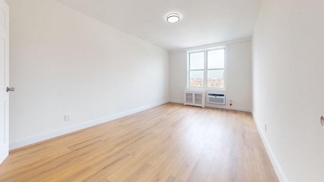 66-15 Thornton Pl Unit 6S, Rego Park, NY 11374 - spare room with light wood-style flooring and radiator