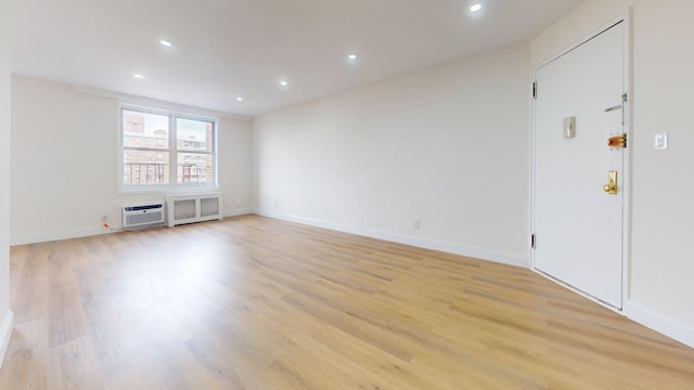 66-15 Thornton Pl Unit 6S, Rego Park, NY 11374 - empty room with light wood-style flooring, radiator heating unit, and recessed lighting