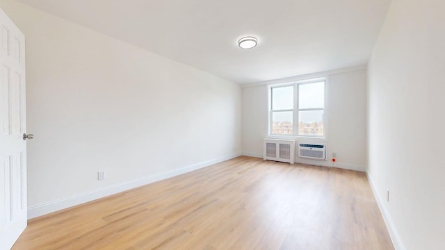 66-15 Thornton Pl Unit 6S, Rego Park, NY 11374 - spare room with light wood-style flooring and radiator heating unit