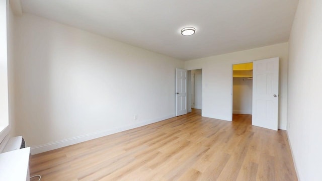 66-15 Thornton Pl Unit 6S, Rego Park, NY 11374 - unfurnished bedroom featuring light wood-style floors and a walk in closet