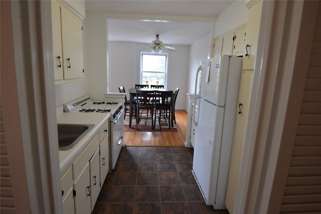 100 S Ocean Ave Unit 4A, Freeport, NY 11520 - kitchen featuring white appliances, a ceiling fan, light countertops, and white cabinetry