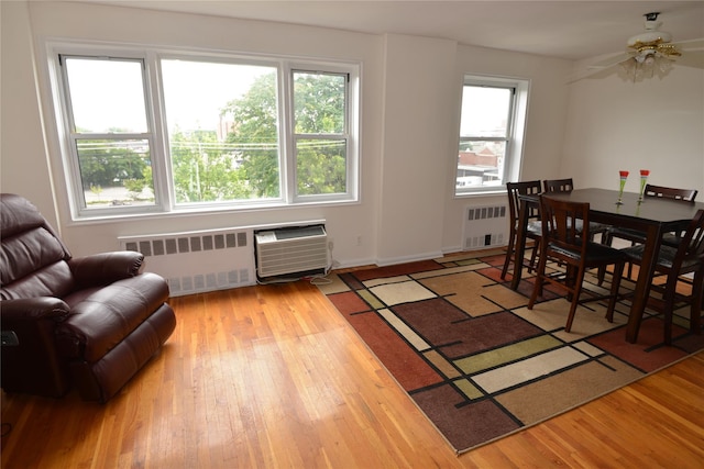 100 S Ocean Ave Unit 4A, Freeport, NY 11520 - dining space with plenty of natural light, radiator heating unit, and wood finished floors