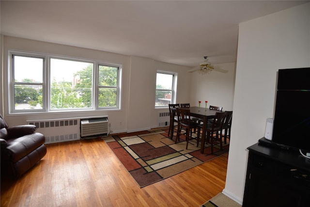 100 S Ocean Ave Unit 4A, Freeport, NY 11520 - dining area featuring radiator, light wood-style floors, and a ceiling fan