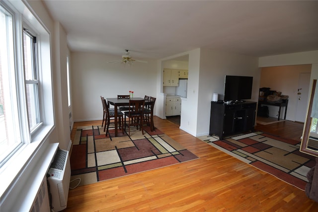 100 S Ocean Ave Unit 4A, Freeport, NY 11520 - dining area with light wood-type flooring, a ceiling fan, and plenty of natural light