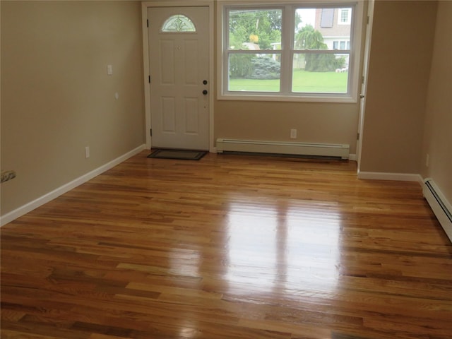 118 Muncy Ave, West Babylon, NY 11704 - foyer with wood finished floors and a baseboard heating unit