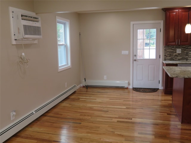 118 Muncy Ave, West Babylon, NY 11704 - unfurnished dining area with baseboard heating, plenty of natural light, light wood-style floors, and a baseboard heating unit