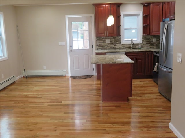 118 Muncy Ave, West Babylon, NY 11704 - kitchen with stainless steel fridge with ice dispenser, a kitchen island, light wood-style floors, and baseboard heating