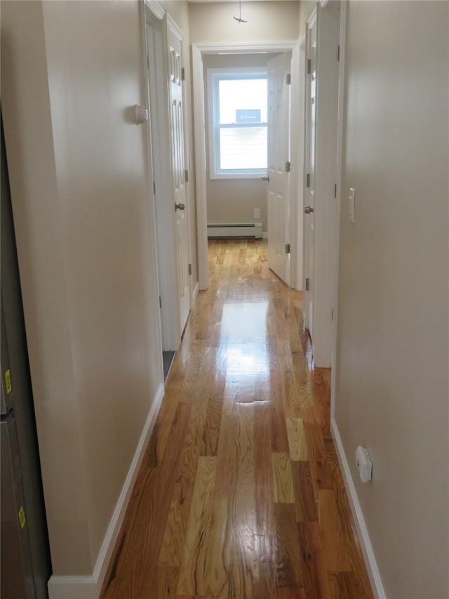 118 Muncy Ave, West Babylon, NY 11704 - corridor with light wood finished floors and baseboard heating