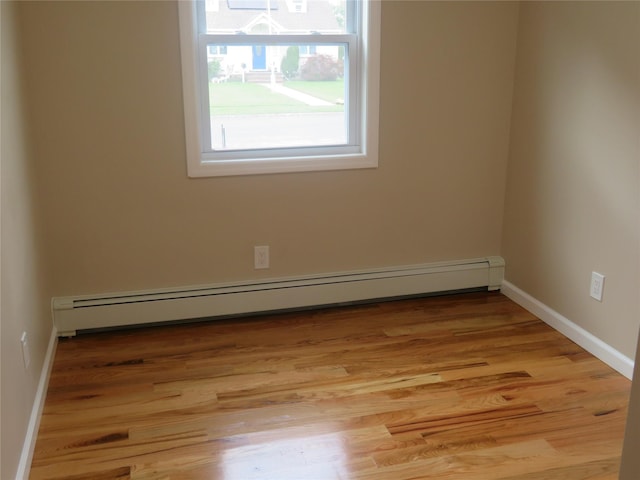 118 Muncy Ave, West Babylon, NY 11704 - unfurnished room featuring a baseboard radiator and light wood-style flooring