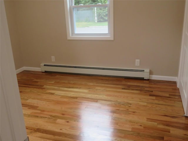 118 Muncy Ave, West Babylon, NY 11704 - empty room featuring a baseboard radiator and light wood finished floors