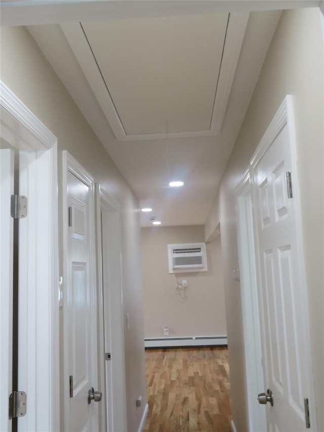 118 Muncy Ave, West Babylon, NY 11704 - corridor featuring attic access, wood finished floors, a baseboard radiator, and a wall mounted air conditioner
