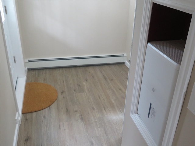118 Muncy Ave, West Babylon, NY 11704 - detailed view of baseboard heating and wood finished floors