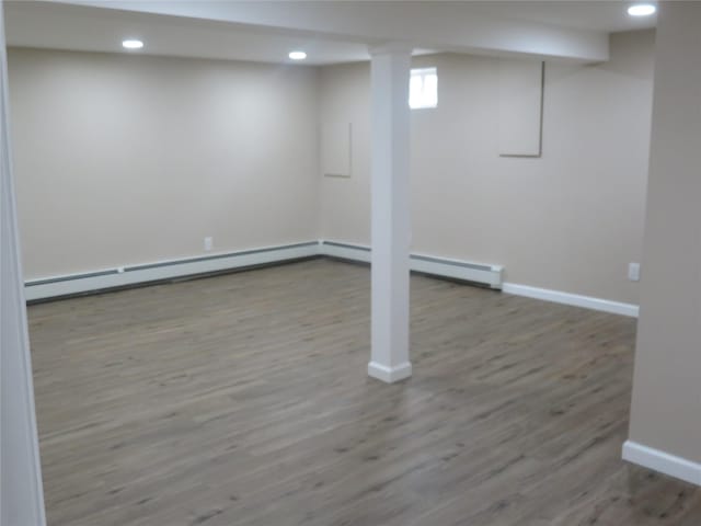 118 Muncy Ave, West Babylon, NY 11704 - basement featuring wood finished floors, recessed lighting, a baseboard heating unit, and baseboard heating