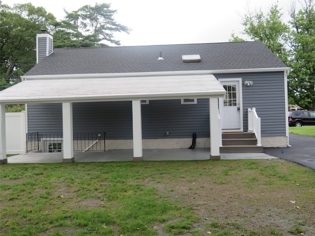 118 Muncy Ave, West Babylon, NY 11704 - rear view of property featuring a chimney, a lawn, and a shingled roof