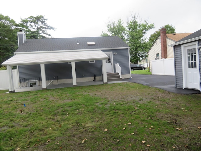 118 Muncy Ave, West Babylon, NY 11704 - rear view of property with a shingled roof and a chimney