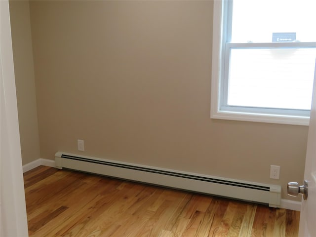 118 Muncy Ave, West Babylon, NY 11704 - spare room with a baseboard radiator, healthy amount of natural light, and light wood-type flooring