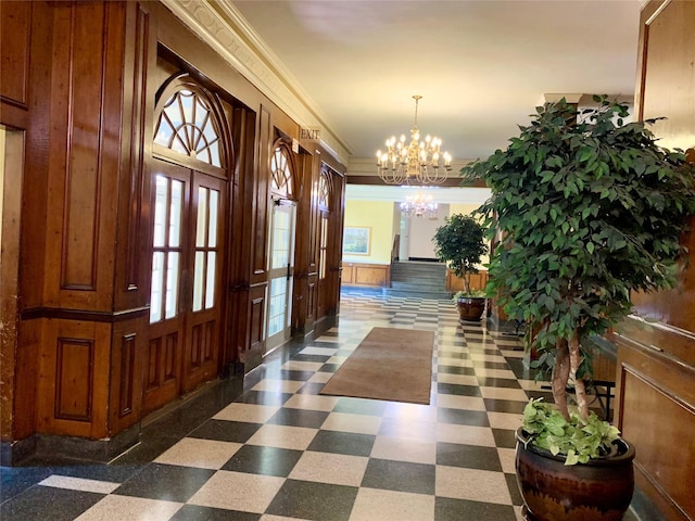 511 W 232nd St Unit E56, Bronx, NY 10463 - foyer featuring a chandelier, plenty of natural light, crown molding, dark floors, and wood walls